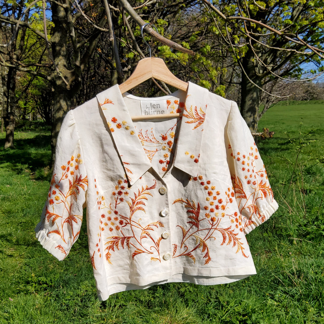 a blouse made from an embroidered tablecloth with puff sleeves and a V-neck